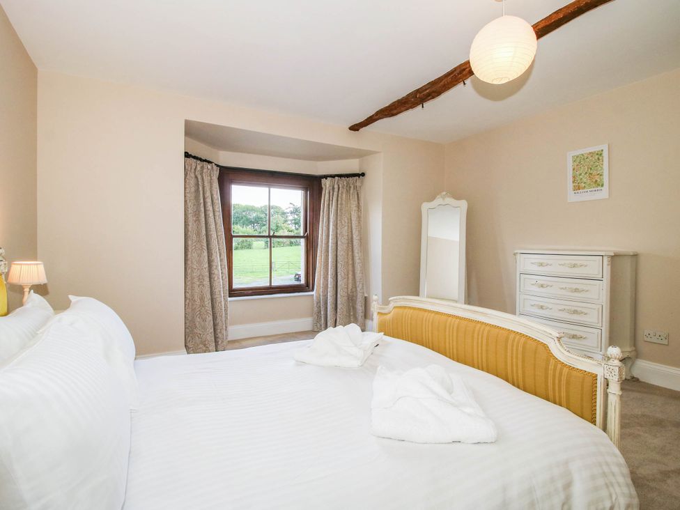 A bedroom with a bed and dresser at Stone House Farm in Cobnash near Leominster