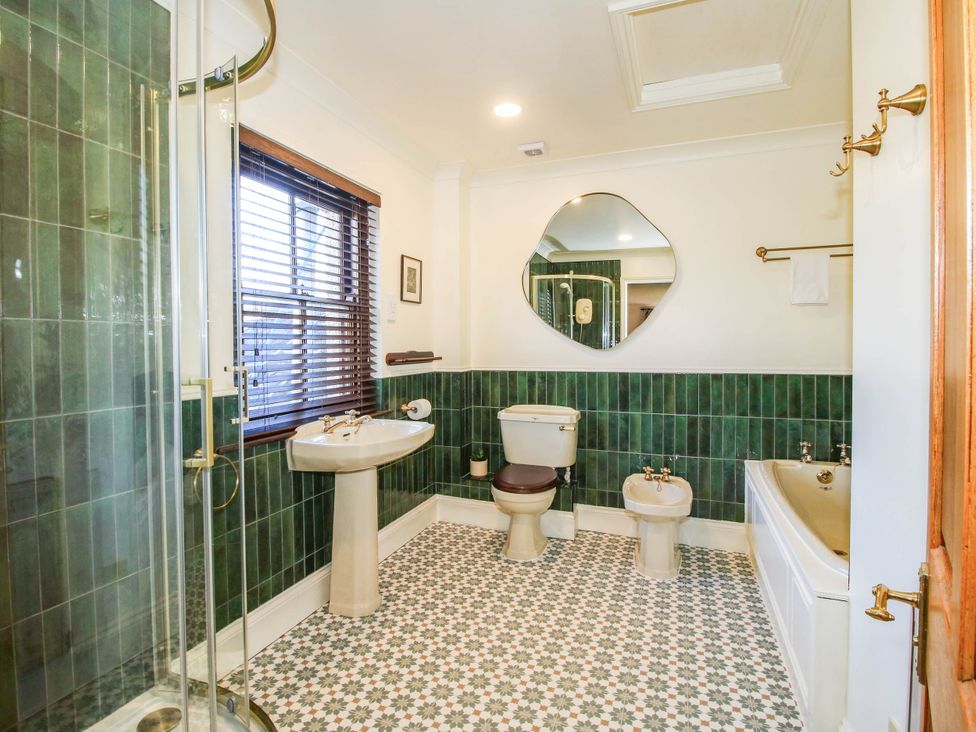 A bathroom with a shower, bathtub, and sink at Stone House Farm in Cobnash near Leominster