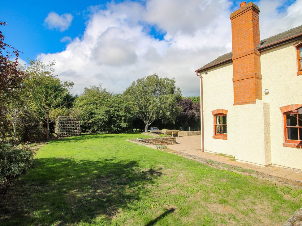 A garden with grass and trees at Stone House Farm in Cobnash near Leominster