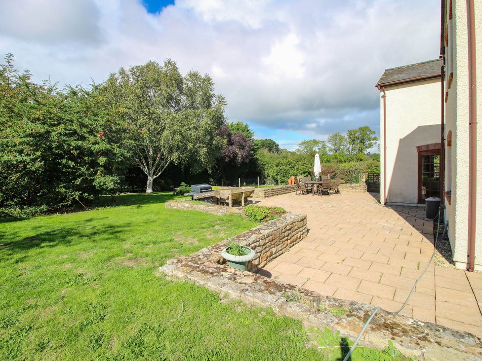 A garden with a patio and seating area at Stone House Farm in Cobnash near Leominster