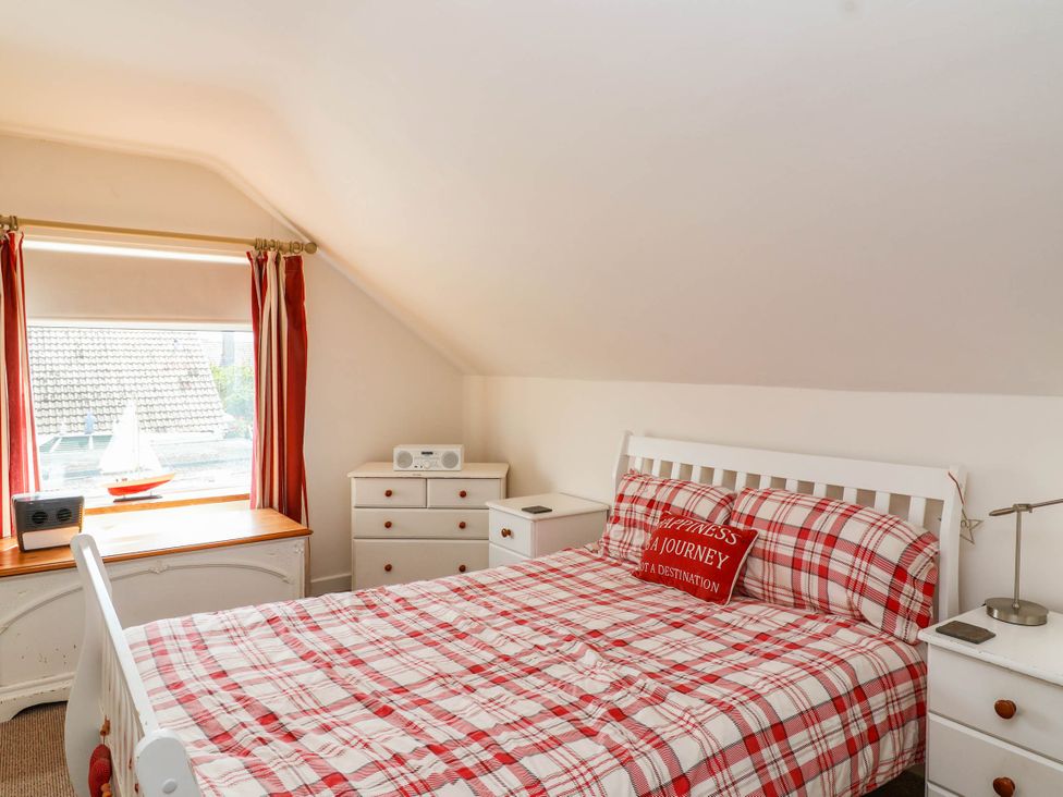 A bedroom with a bed and window at 56 Steart Gardens in Burnham-on-Sea