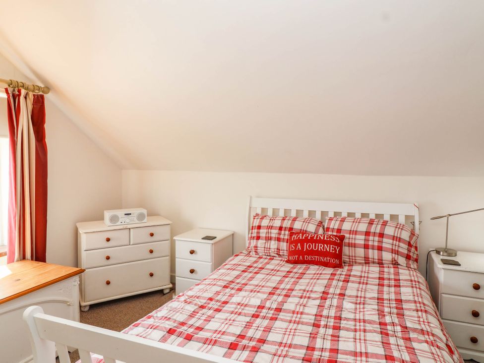 A bedroom with a bed and dresser at 56 Steart Gardens in Burnham-on-Sea