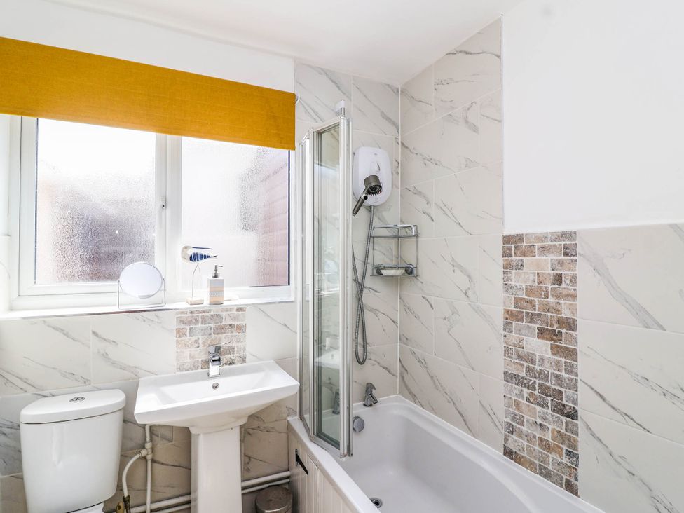 A bathroom featuring a sink, bathtub, and shower at 56 Steart Gardens Burnham-on-Sea