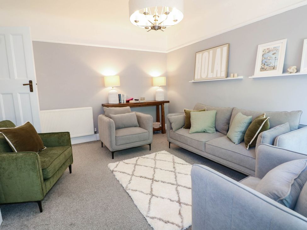 A living room with a sofa and armchairs at 41 Terminus Avenue Bexhill-On-Sea