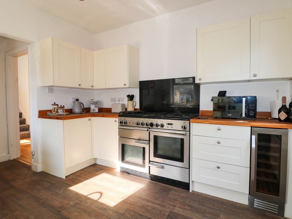 A kitchen with cabinets and appliances at 41 Terminus Avenue Bexhill-On-Sea