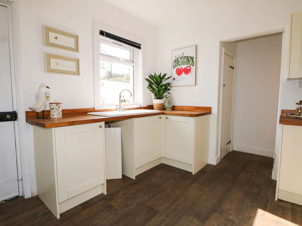 A kitchen with cabinets and a sink at 41 Terminus Avenue Bexhill-On-Sea