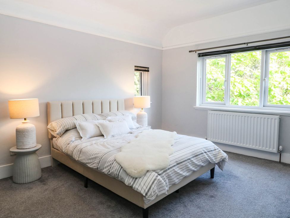 A bedroom with a bed and lamps at 41 Terminus Avenue Bexhill-On-Sea