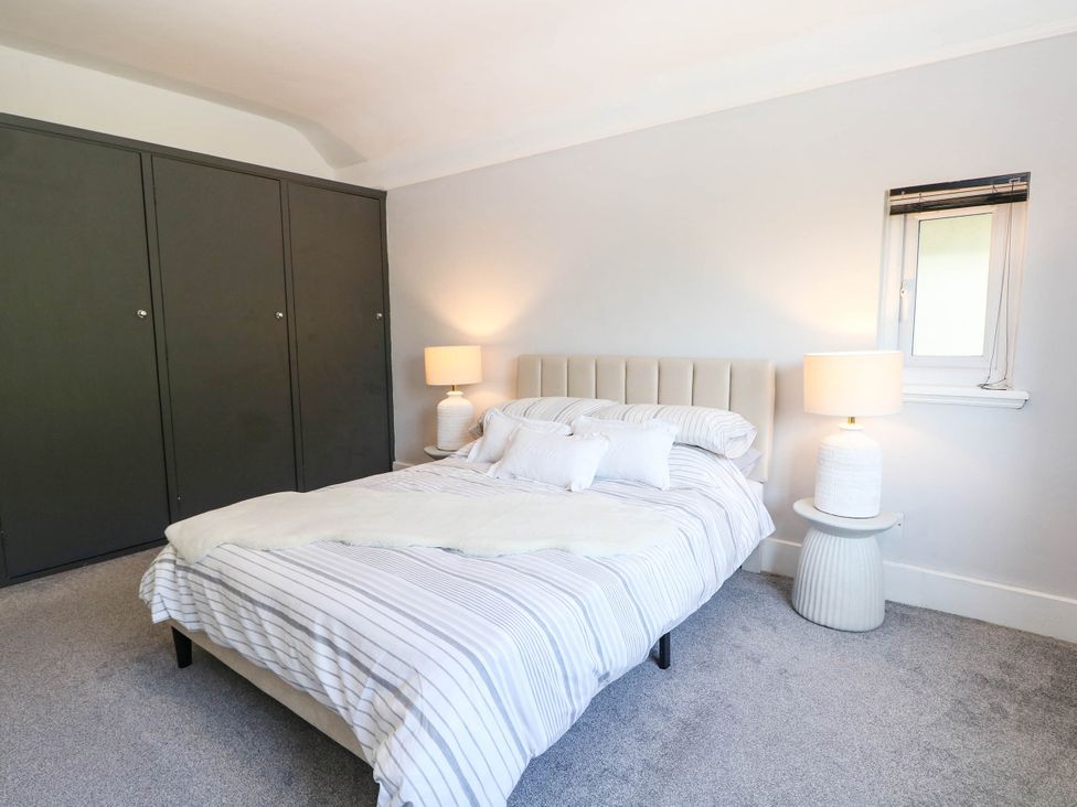 A bedroom with a bed and wardrobe at 41 Terminus Avenue Bexhill-On-Sea