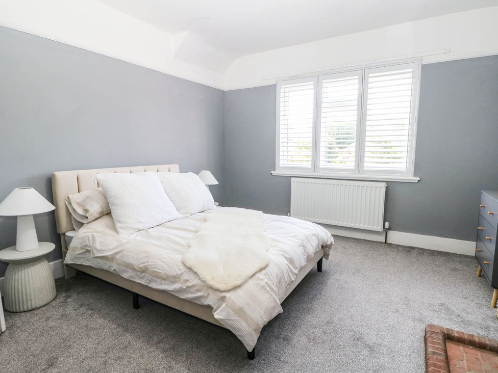 A bedroom with a bed and lamp at 41 Terminus Avenue Bexhill-On-Sea
