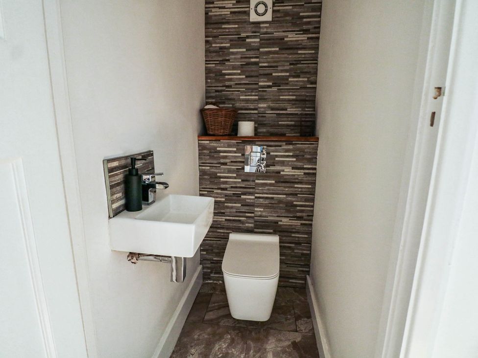 A bathroom with a toilet and sink at 41 Terminus Avenue Bexhill-On-Sea