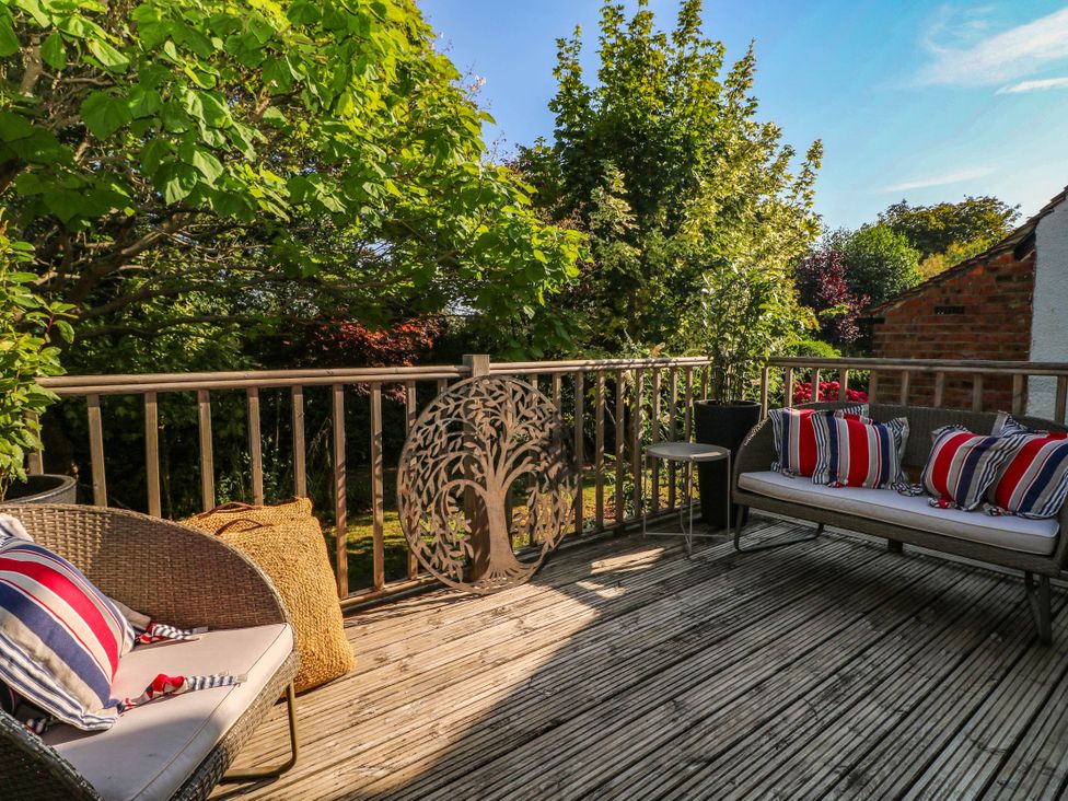 An outdoor area with seating and trees at 41 Terminus Avenue Bexhill-On-Sea