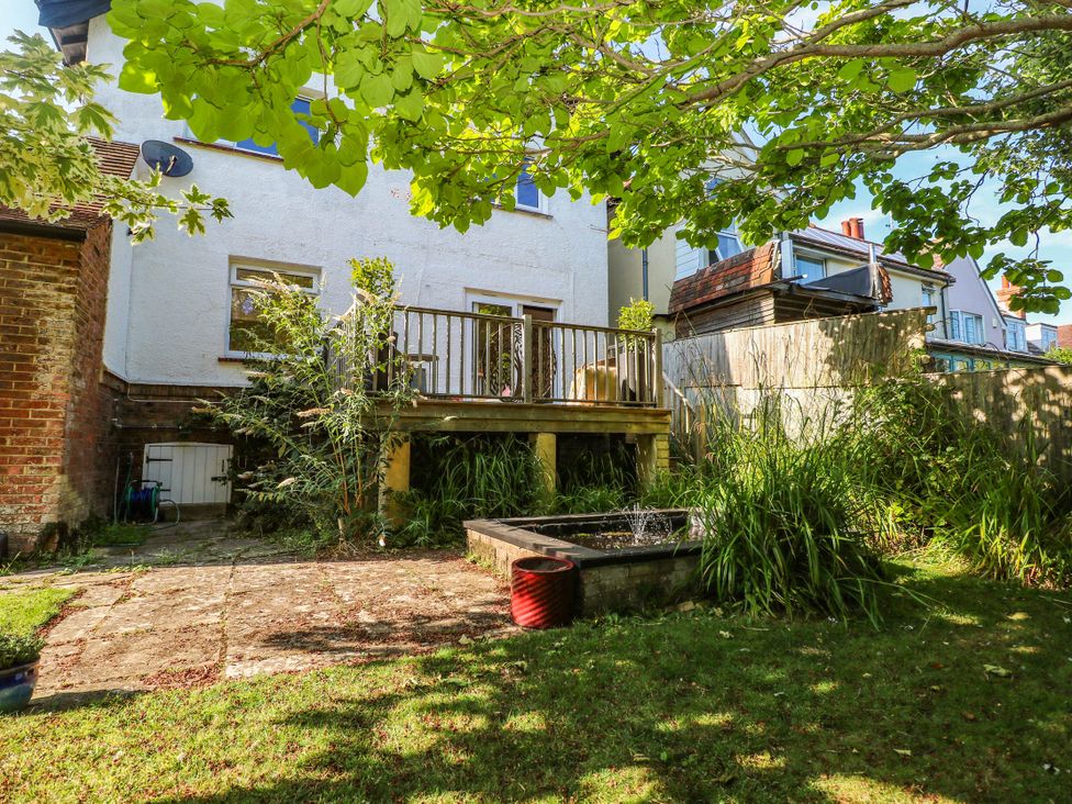 A garden with decking and a fountain at 41 Terminus Avenue Bexhill-On-Sea