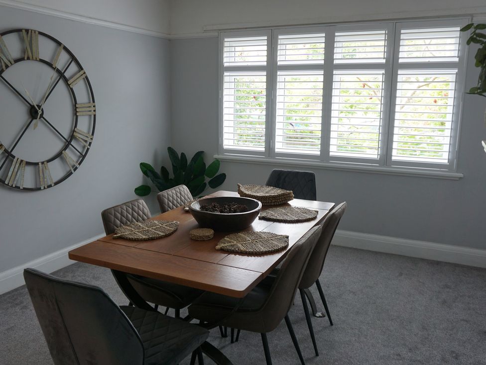 A dining room with a table and chairs at 41 Terminus Avenue Bexhill-On-Sea