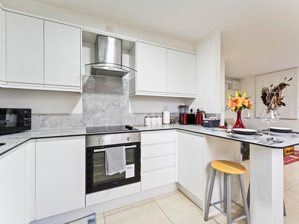 A kitchen with cabinets, appliances, and dining ware at 2 Pump House in Birmingham