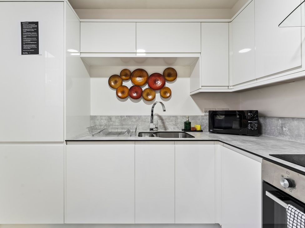 A kitchen with cabinets, sink, and microwave at 2 Pump House in Birmingham