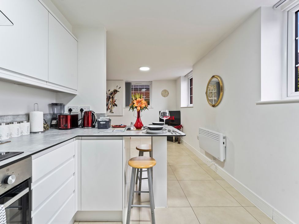 A kitchen with appliances and a small dining area at 2 Pump House Birmingham