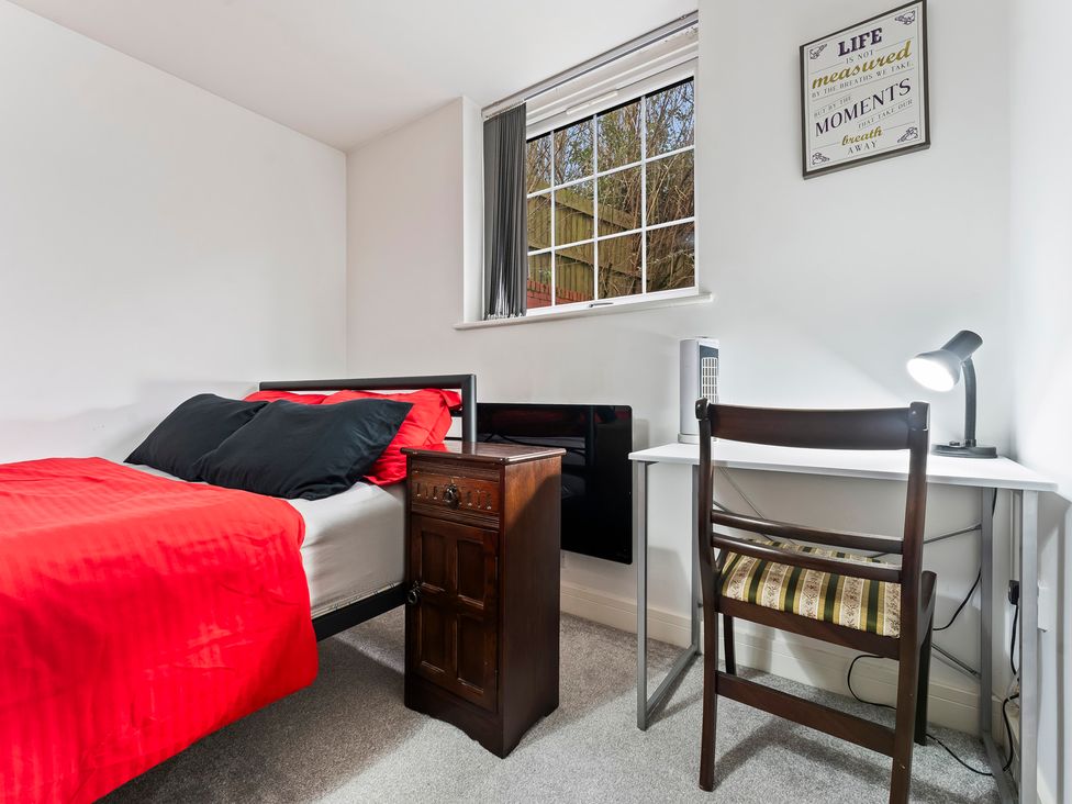 A bedroom with a bed, desk and window at 2 Pump House Birmingham