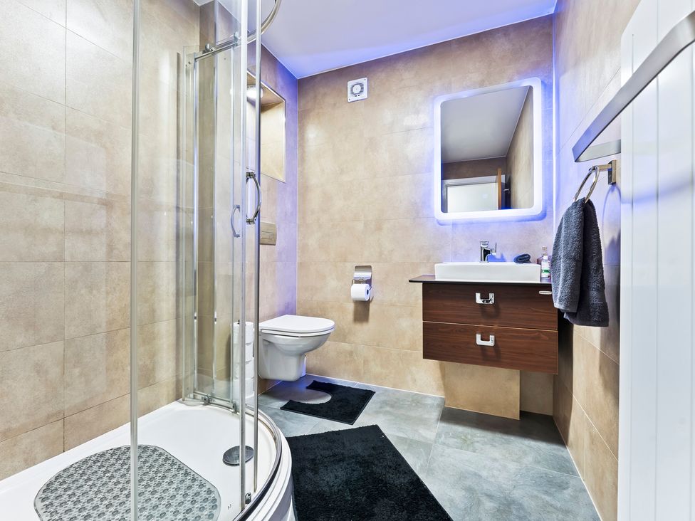 A bathroom with a shower and sink at 2 Pump House in Birmingham