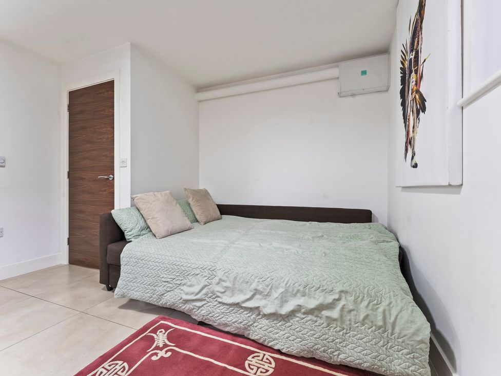 A bedroom with a bed and pillows at 2 Pump House in Birmingham