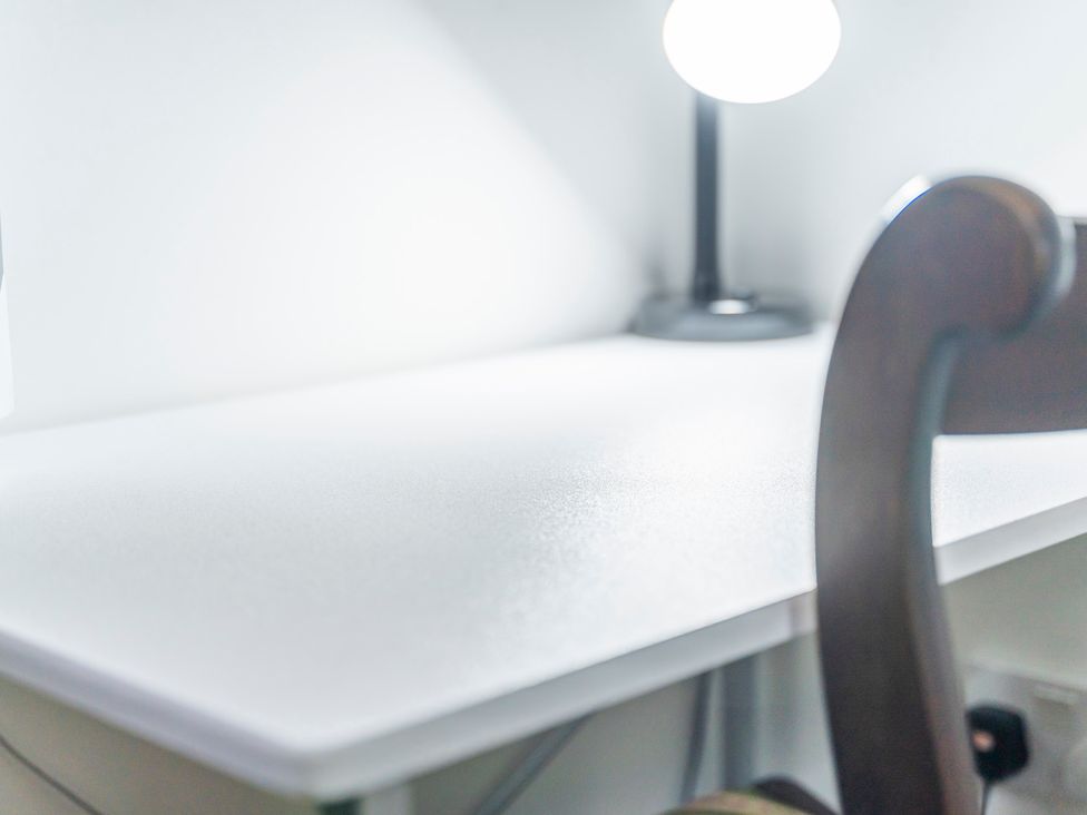 An office desk with a lamp and a chair at 2 Pump House Birmingham