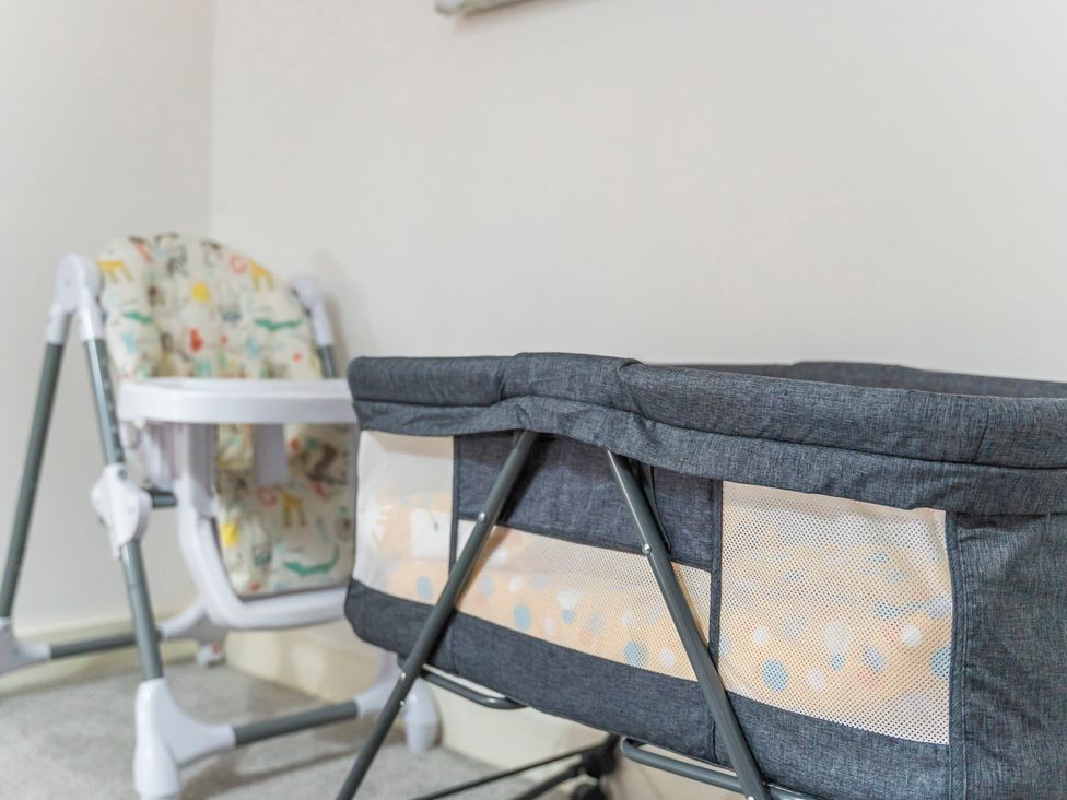 A nursery with a bassinet and a bouncer at 2 Pump House Birmingham