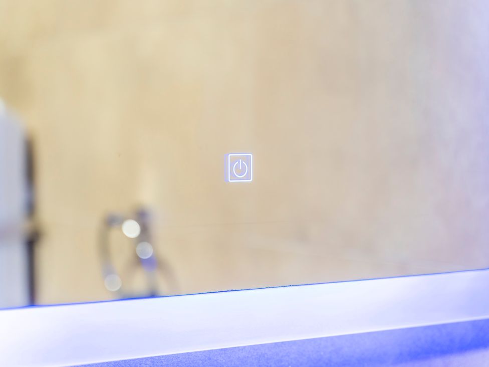 A mirror with a power button indicator at 2 Pump House in Birmingham