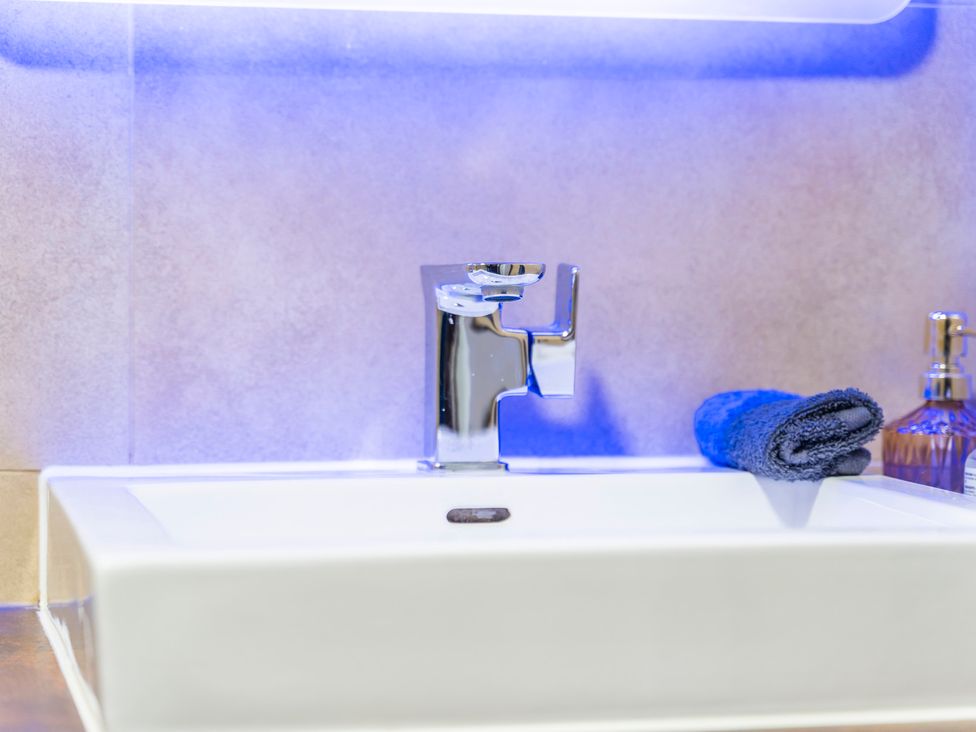 A sink with a faucet and towel at 2 Pump House in Birmingham