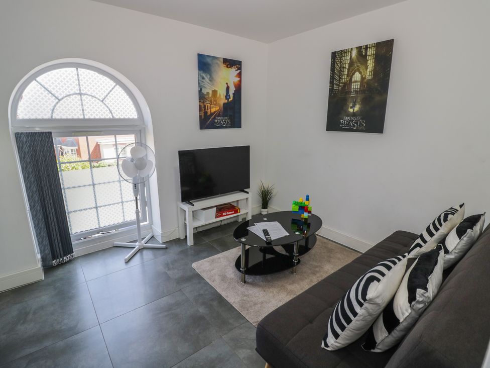 A living room with a television and a coffee table at 3 Pump House in Birmingham