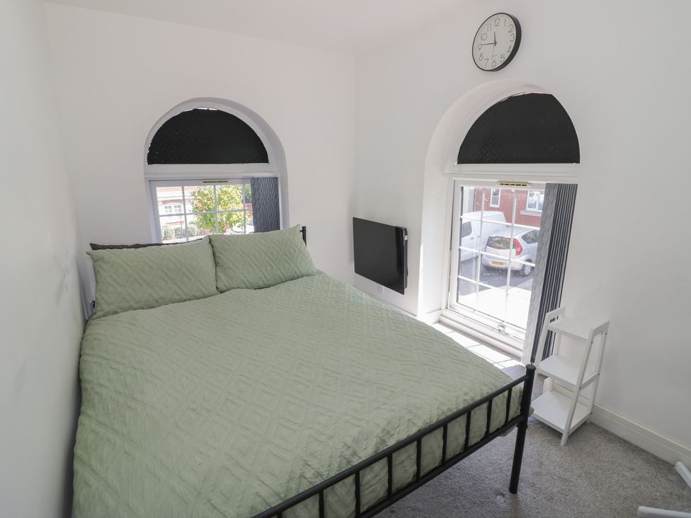 A bedroom with a bed and a television at 3 Pump House in Birmingham