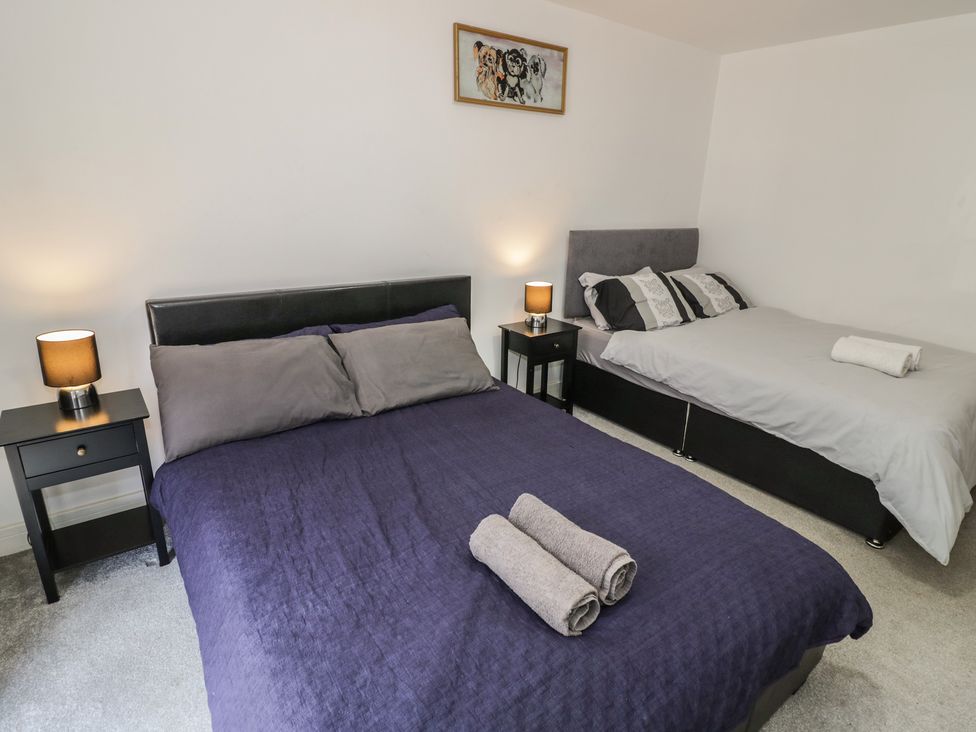 A bedroom with two beds and bedside tables at 3 Pump House in Birmingham