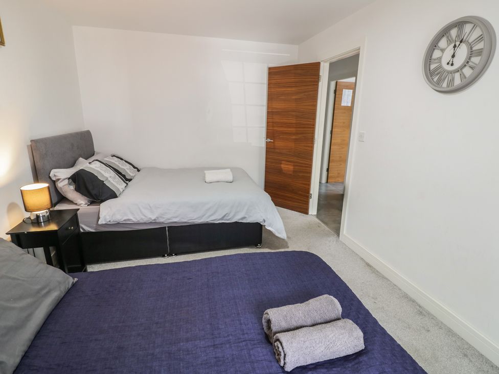 A bedroom with two beds and a lamp at 3 Pump House in Birmingham
