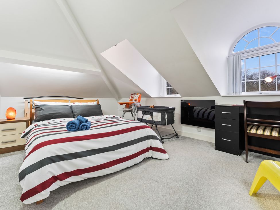 A bedroom with a bed and crib at 5 Pump House in Birmingham