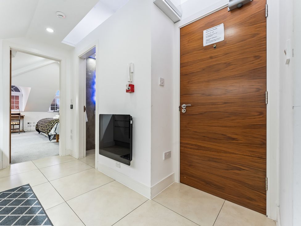 A hallway with a door and window at 5 Pump House in Birmingham