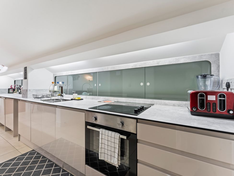 A kitchen with modern appliances at 5 Pump House in Birmingham