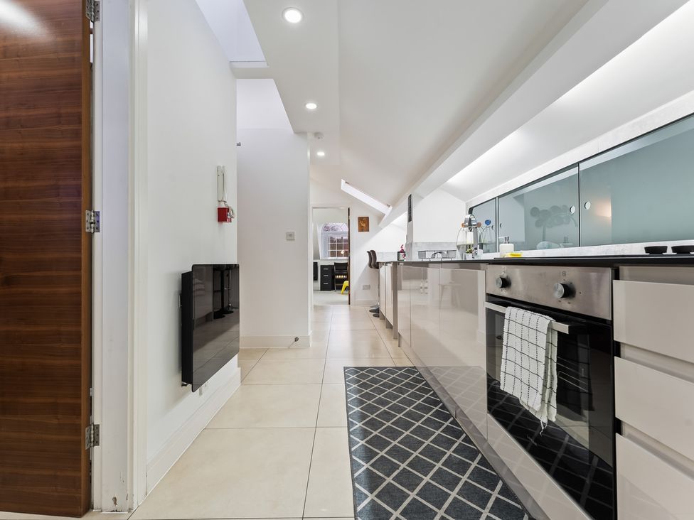 A kitchen with cabinets and appliances at 5 Pump House in Birmingham