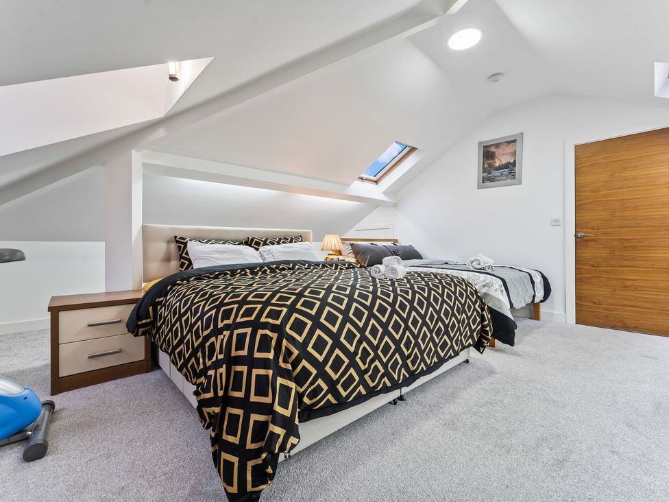 A bedroom with a bed and nightstand at 5 Pump House Birmingham