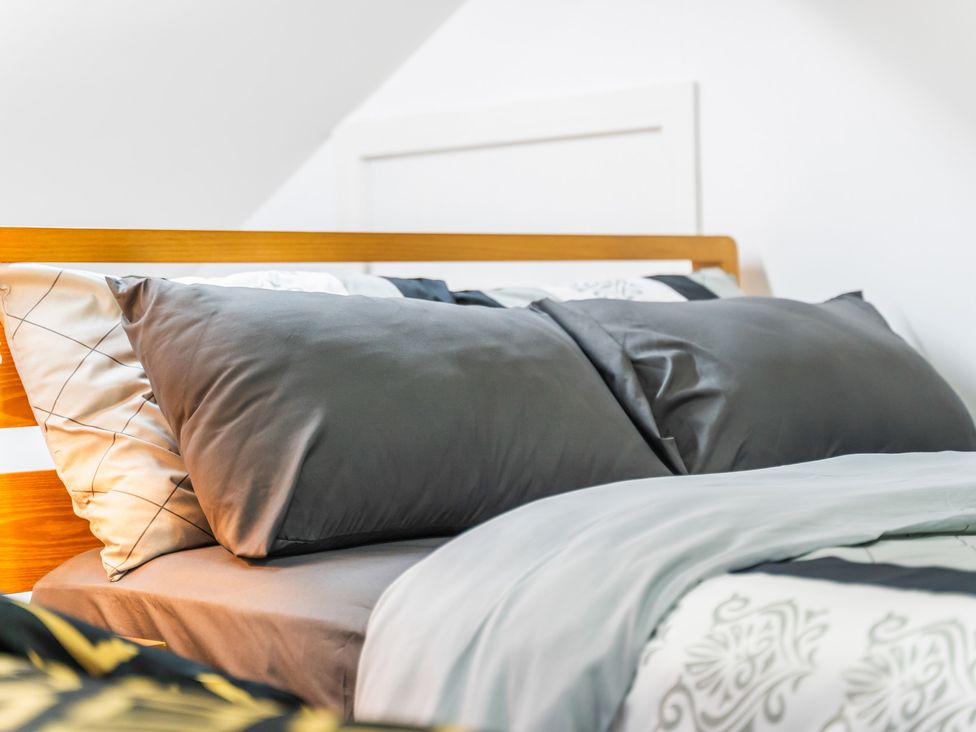A bed with pillows and blankets at 5 Pump House in Birmingham