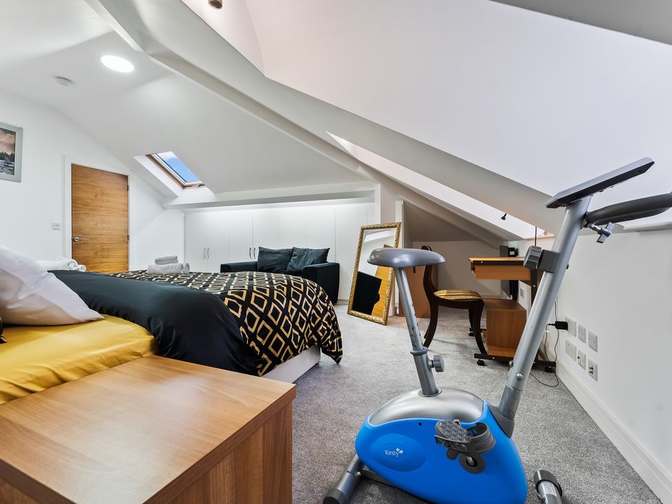 A bedroom with a bed and exercise bike at 5 Pump House in Birmingham