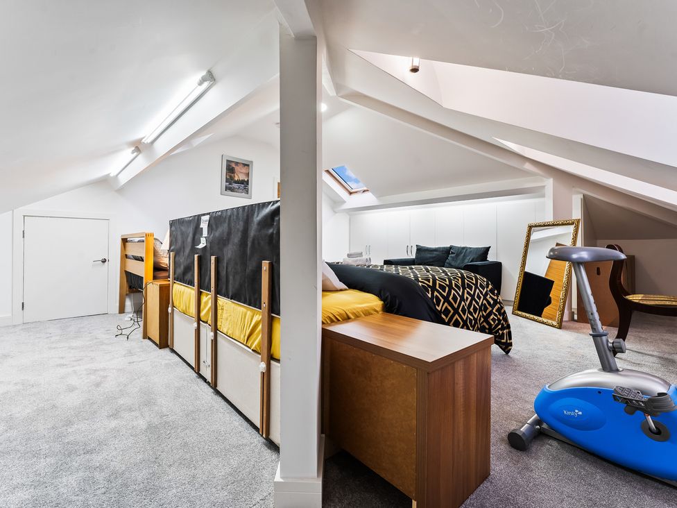 A bedroom with a bed and exercise bike at 5 Pump House in Birmingham