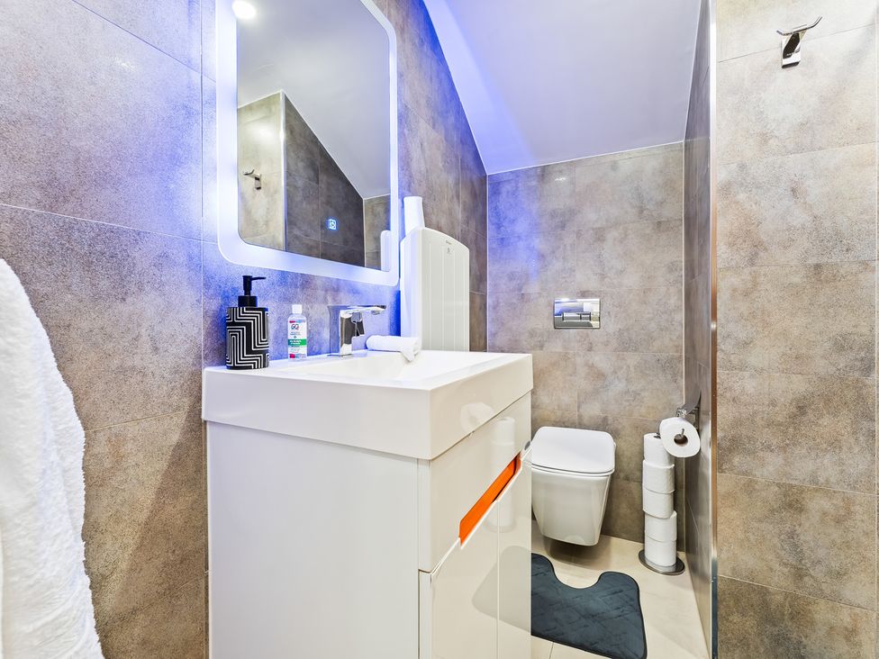 A bathroom featuring a sink, toilet, and mirror at 5 Pump House Birmingham