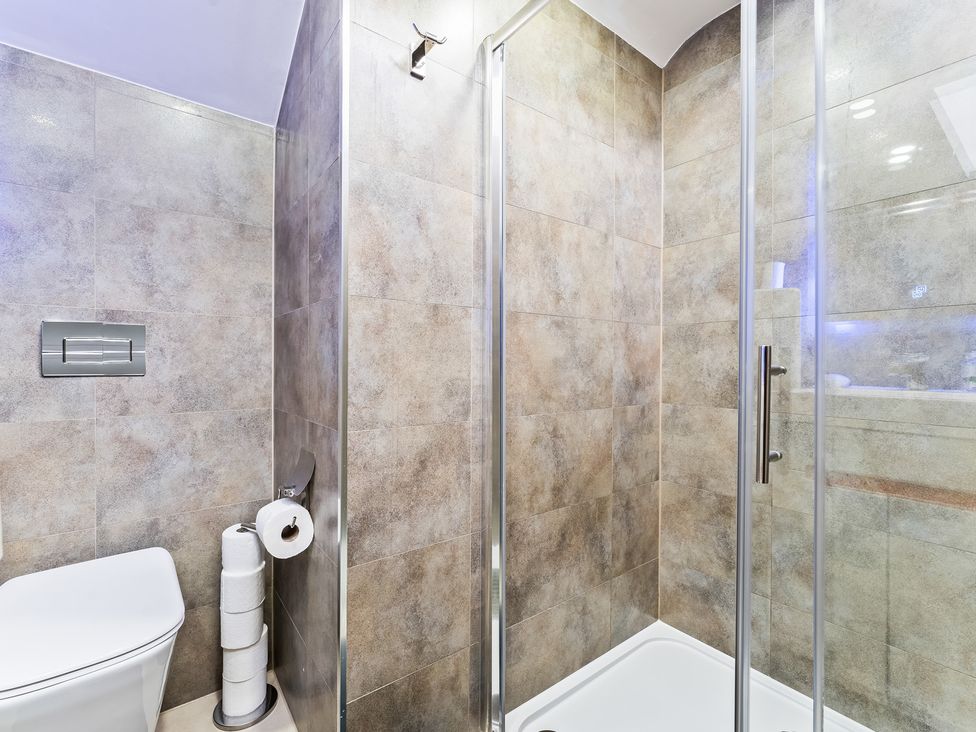 A bathroom with a shower and toilet at 5 Pump House Birmingham