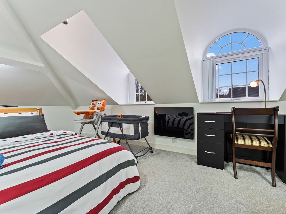 A bedroom with a bed and a desk at 5 Pump House in Birmingham