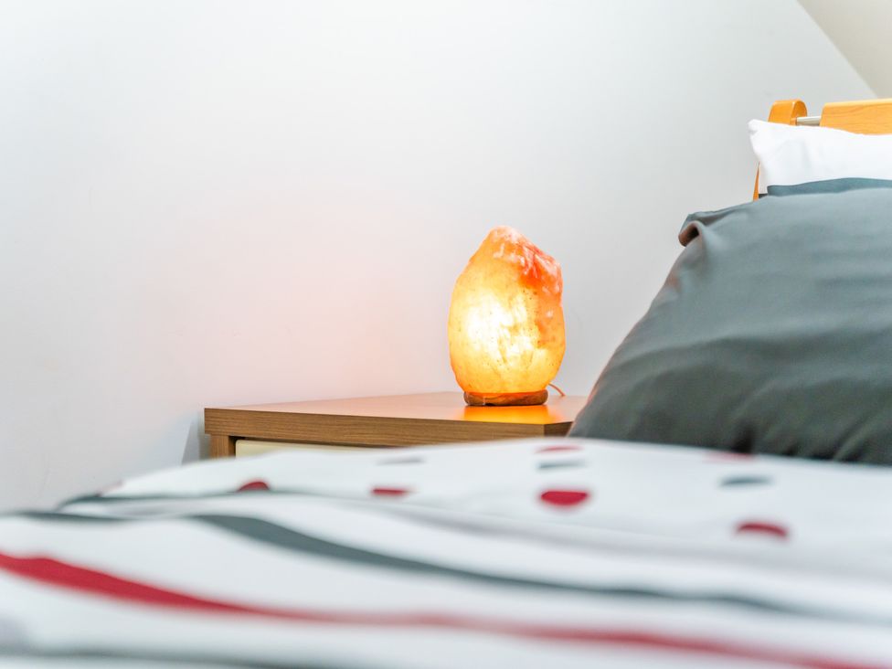A bedroom with a bedside table and lamp at 5 Pump House in Birmingham