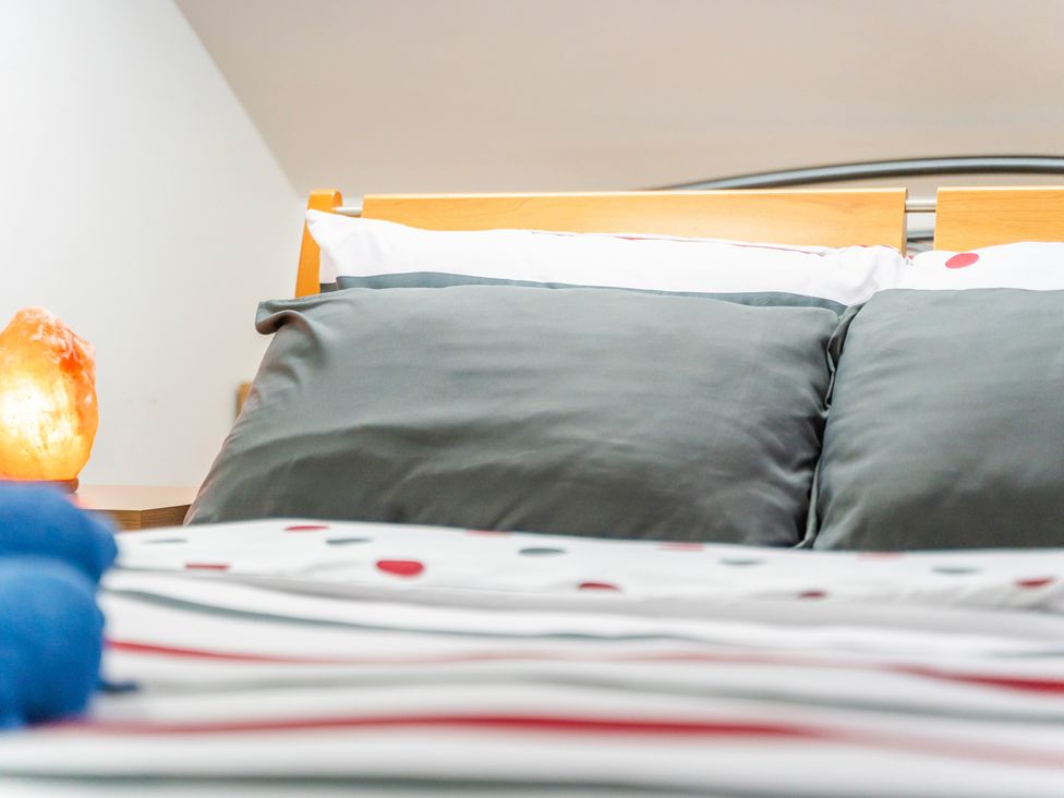 A bed with pillows and a lamp at 5 Pump House in Birmingham