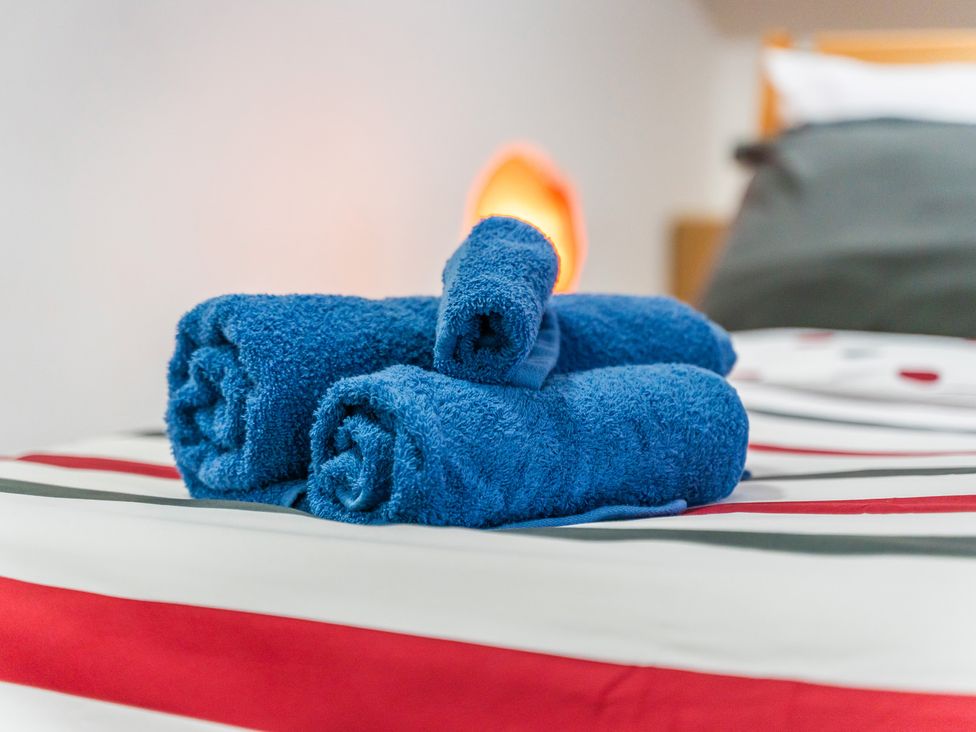 Blue towels on a bed at 5 Pump House in Birmingham