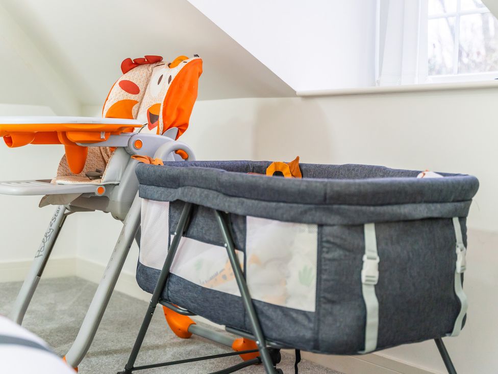 A nursery with a high chair and bassinet at 5 Pump House in Birmingham