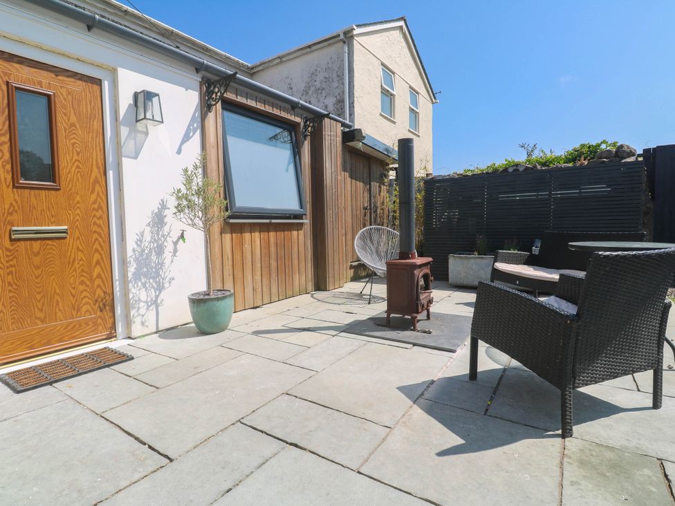 An outdoor area with a wooden door and seating at The Lookout in Redruth
