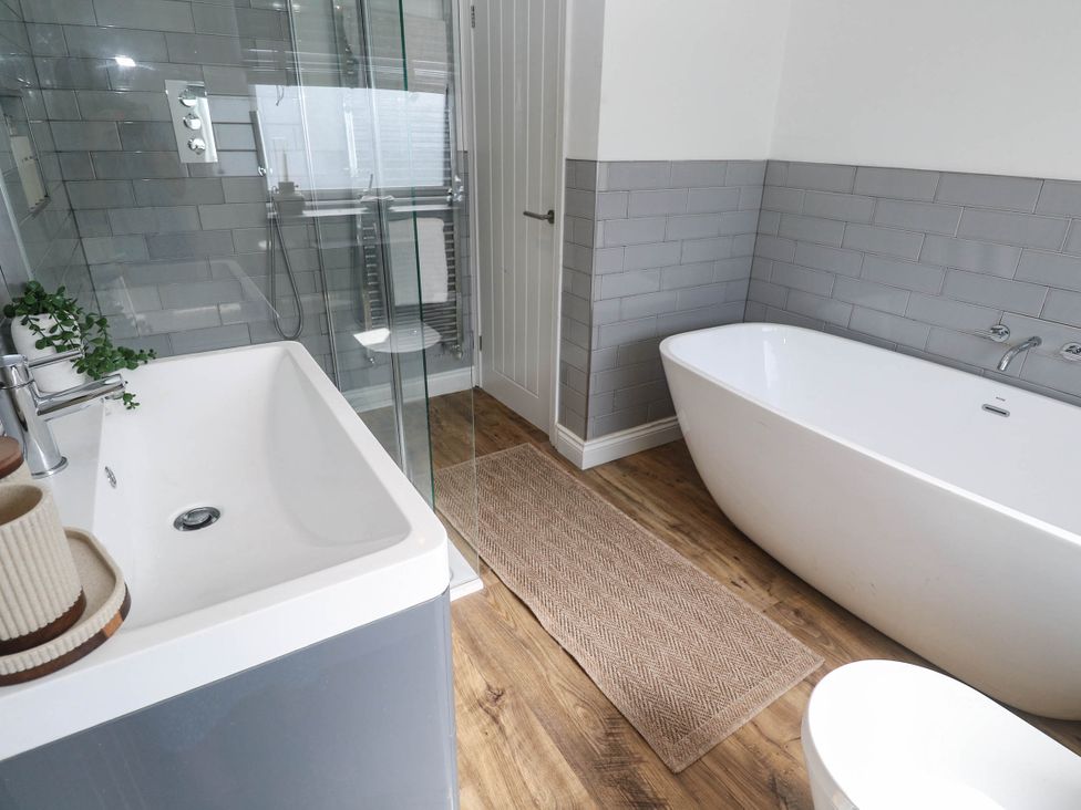 A bathroom featuring a bathtub and shower at The Lookout in Redruth