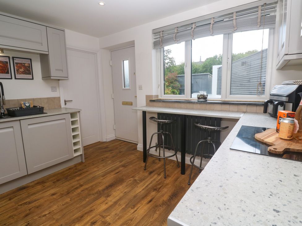 A kitchen with bar counter and stools at The Lookout in Redruth