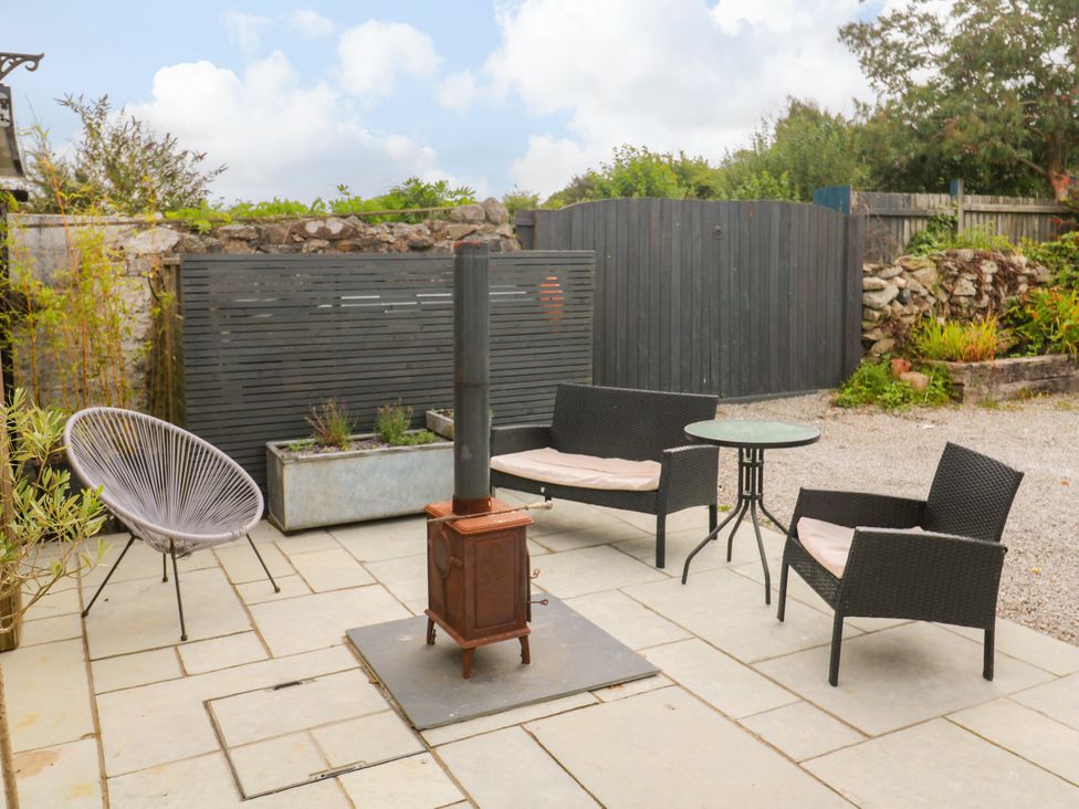 An outdoor seating area with chairs and a table at The Lookout Redruth